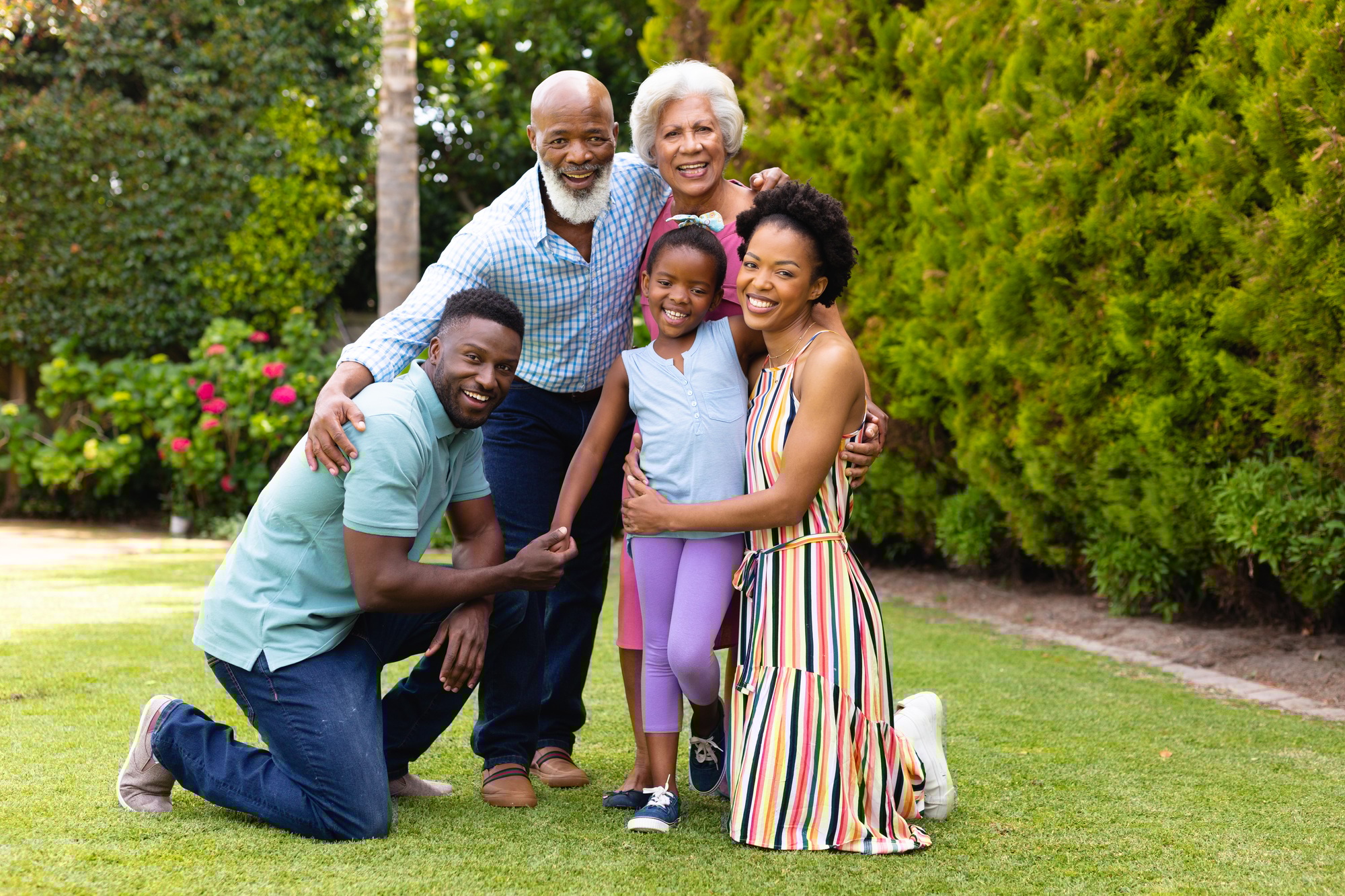 Portrait of cheerful three generational african american family at the backyard garden